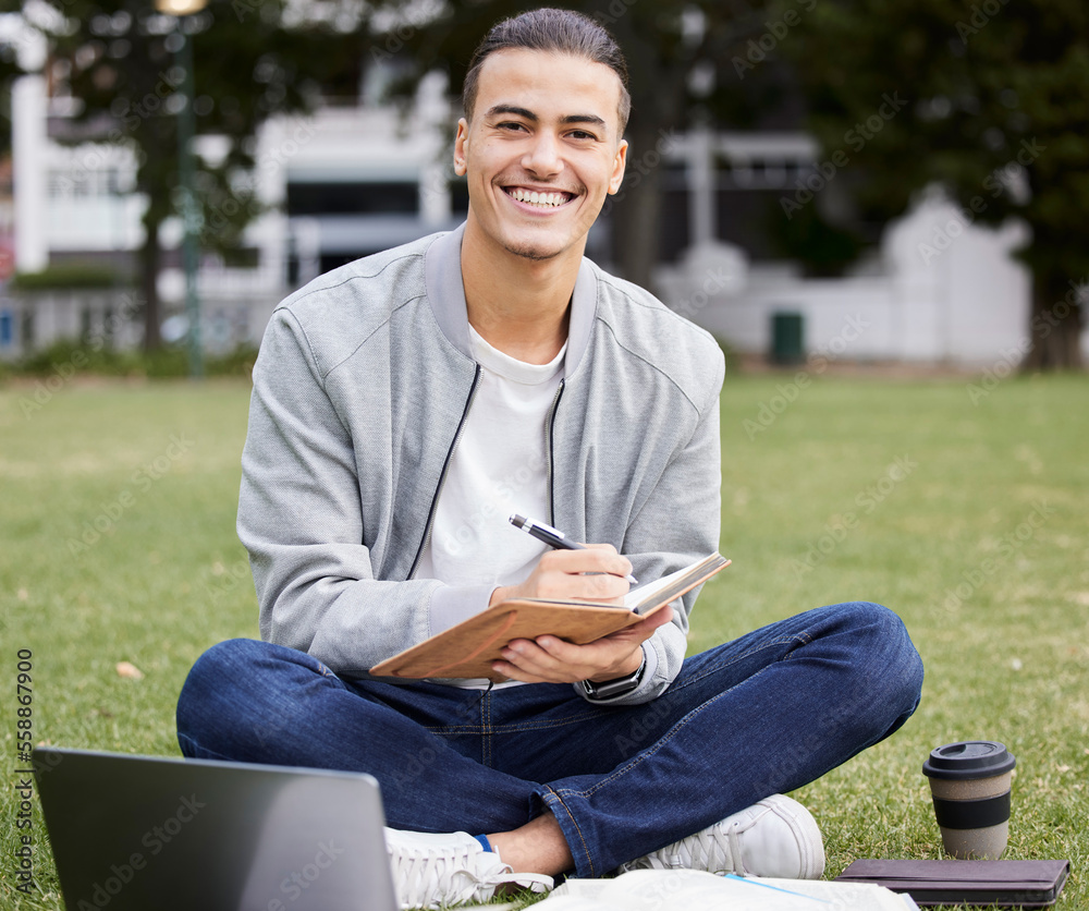 Obraz premium Study, laptop and student portrait in park writing at university, college or campus for research, planning schedule and scholarship. Happy man relax and learning with technology and notebook for exam