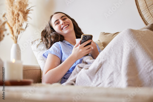 Phone, sofa and relax woman typing post to social media app, online blog or doing internet web search. Laugh, networking communication and gen z girl reading meme, news or contact social network user
