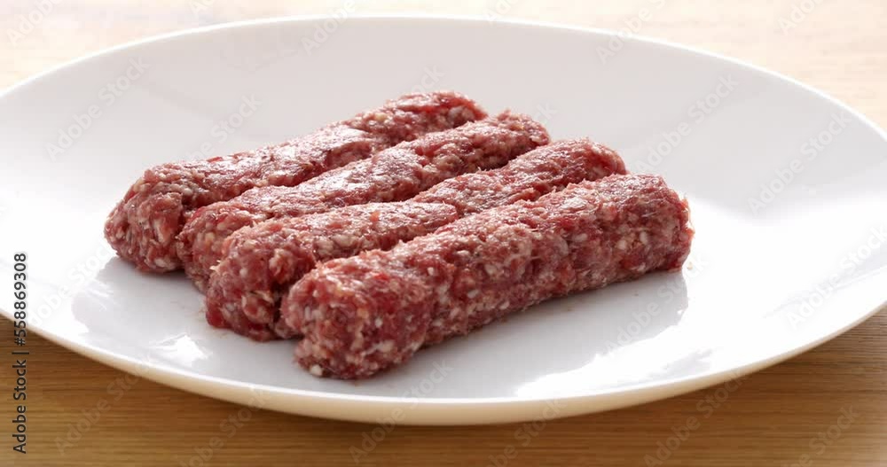 sausages from raw minced meat on a white plate. national Balkan food sausages from raw minced meat on a white plate. national Balkan food