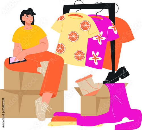 Second hand shop and swap party. Concept of internet flea market and clothing donation. Woman with a phone sits on boxes with packed clothes.