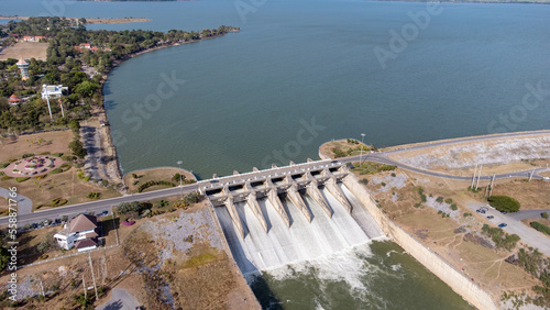 An aerial view over the Pasak Jolasid dam, Lopburi Province, Thailand. Tracking the movement of the floodgates that are releasing water into rural canals in enormous amounts of water. photo