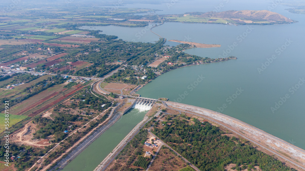 An aerial view over the Pasak Jolasid dam, Lopburi Province, Thailand. Tracking the movement of the floodgates that are releasing water into rural canals in enormous amounts of water. An aerial view over the Pasak Jolasid dam, Lopburi Province, Thailand. Tracking the movement of the floodgates that are releasing water into rural canals in enormous amounts of water.