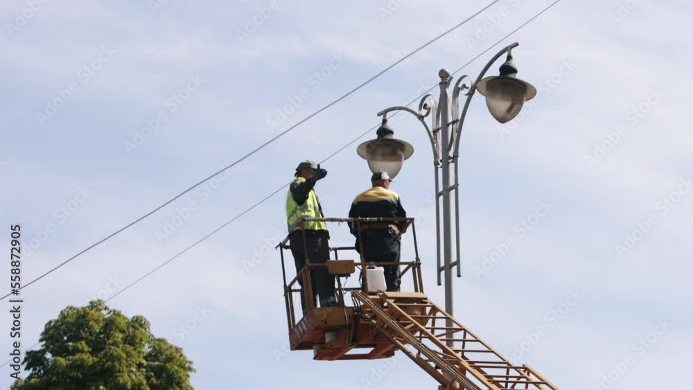 street lamp, Municipal worker, equipment installs. Street light repair
