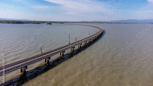Wallpaper Mural Aerial view of an amazing travel train parked on a floating railway bridge over the water of the lake in Pa Sak Jolasid dam with blue sky at Lopburi, Thailand. Torontodigital.ca