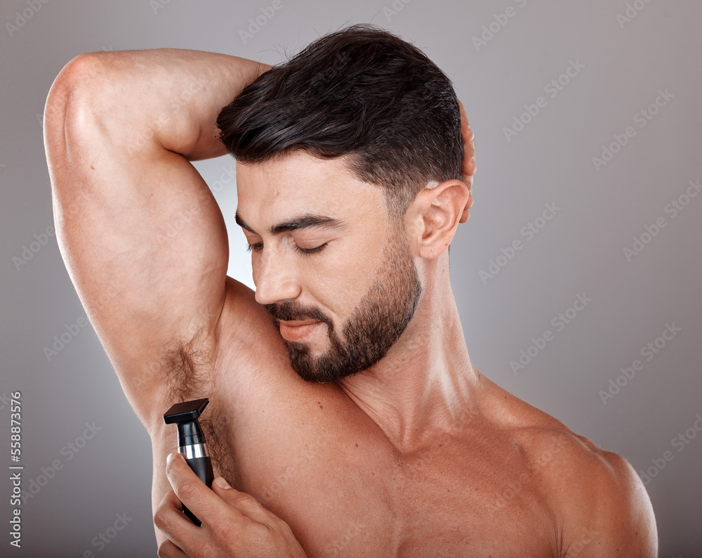 Man, razor and armpit hair for skincare wellness, hygiene grooming and natural self care cosmetics treatment in grey studio background. Model, shaving and dermatology cleaning or hair removal routine Man, razor and armpit hair for skincare wellness, hygiene grooming and natural self care cosmetics treatment in grey studio background. Model, shaving and dermatology cleaning or hair removal routine