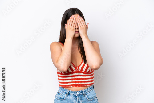 Young Brazilian woman isolated on white background covering eyes by hands