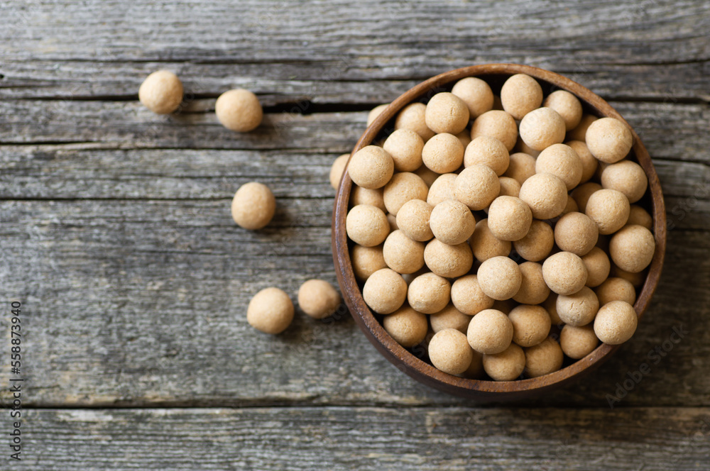 Brown Soy-covered Chickpeas with sauce in wooden bowl, traditional turkish coated nut Brown Soy-covered Chickpeas with sauce in wooden bowl, traditional turkish coated nut