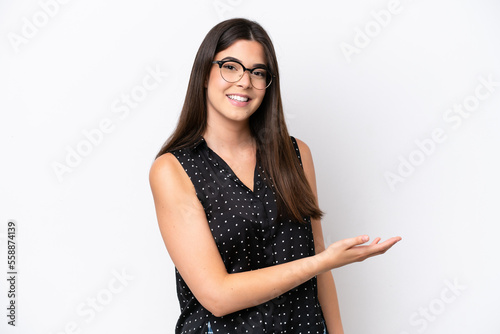 Young Brazilian woman isolated on white background presenting an idea while looking smiling towards