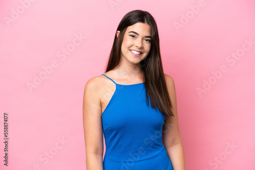 Young Brazilian woman isolated on pink background laughing