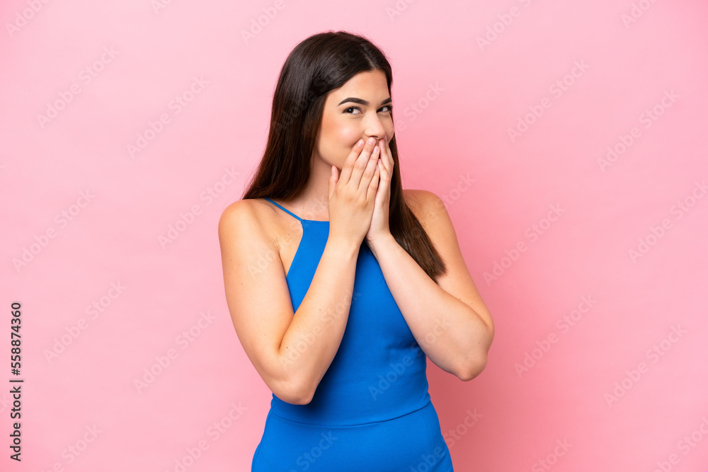 Young Brazilian woman isolated on pink background happy and smiling covering mouth with hands Young Brazilian woman isolated on pink background happy and smiling covering mouth with hands
