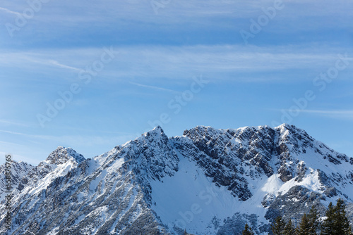Beautiful panorama of snowy mountains landscape against the blue sky and clouds. Brandnertal, Austria