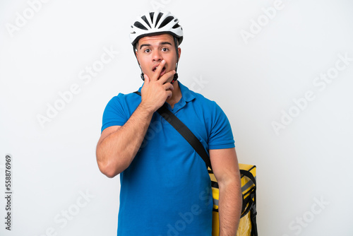 Young caucasian man with thermal backpack isolated on white background surprised and shocked while looking right