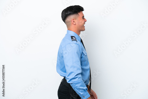 Young police caucasian man isolated on white background laughing in lateral position