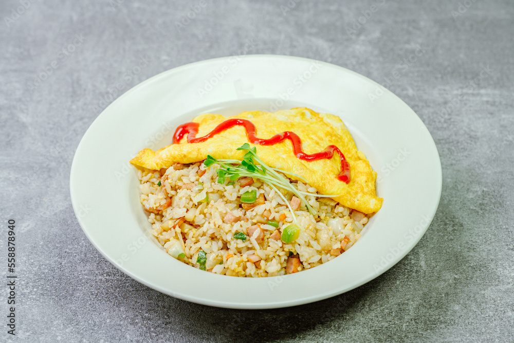 Omelet rice dish served on a white plate Omelet rice dish served on a white plate