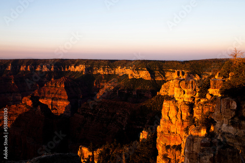 The sunrise shines on the cliffs near Point Imperial located on The Grand Canyon's North Rim in Grand Canyon National Park, Arizona. photo