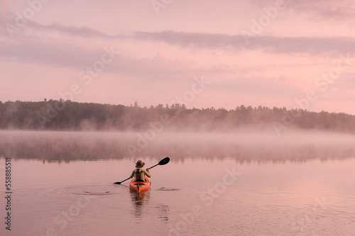 Kayaking on Starrett Lake at sunrise, Northern Highland American Legion State Forest, Wisconsin, USA photo