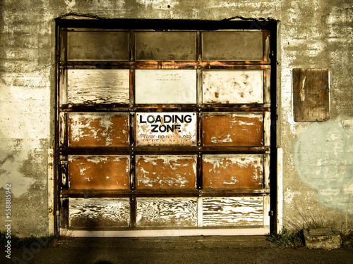 View of an old garage door and loading zone sign in Seattle, Washington. photo