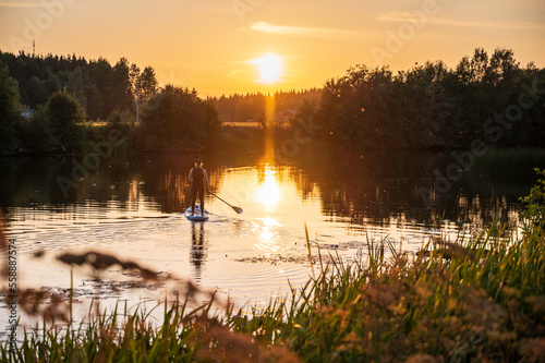 Woman paddling on a Stand up Paddle Board. Nykarleby/Uusikaarlepyy, Finland.