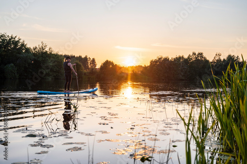 Woman paddling on a Stand up Paddle Board. Nykarleby/Uusikaarlepyy, Finland.