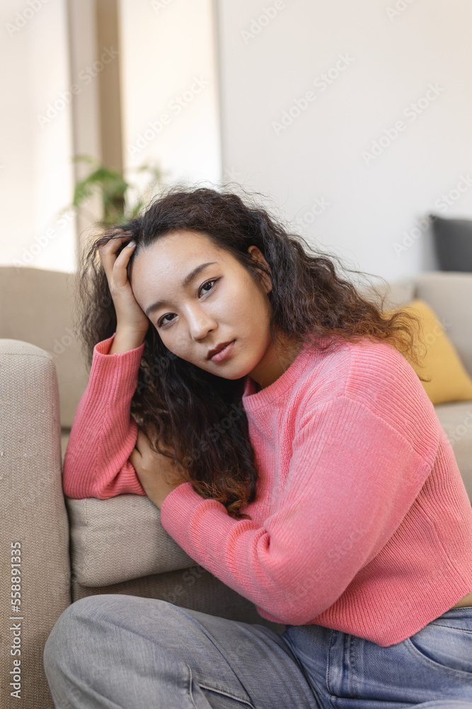 Portrait of beautiful young Asian woman looking at camera. Beautiful woman smiling at home. Portrait of beautiful young Asian woman looking at camera. Beautiful woman smiling at home.