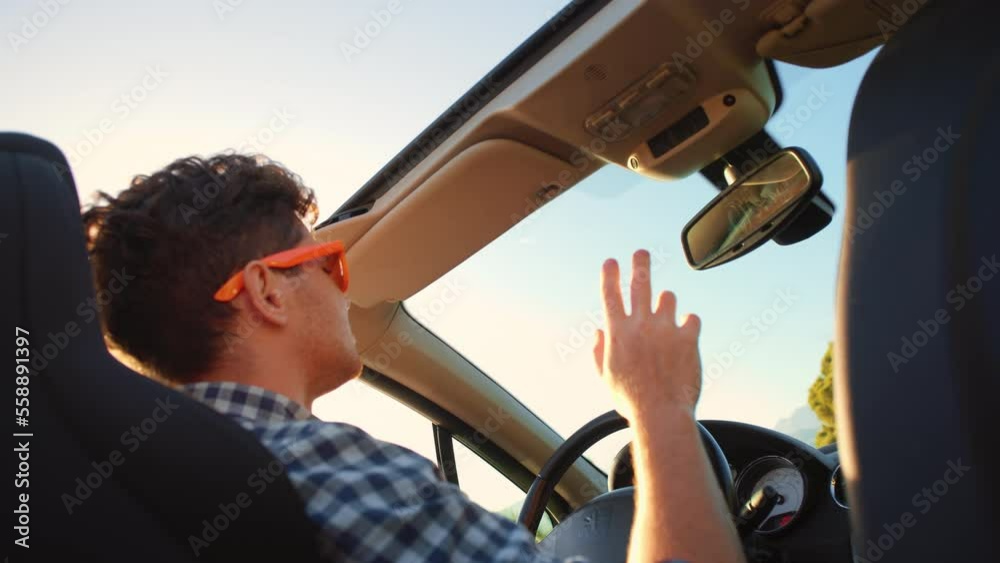 custom made wallpaper toronto digitalYoung stylish man in sunglasses driving cabriolet car waving and dancing hand at golden sunset. Concept of success, tourism and rental. Happy smiling male tourist travel in California. Summer vacation