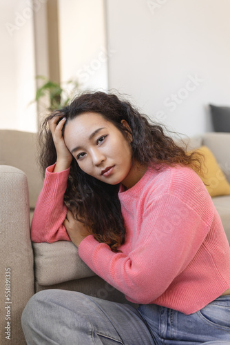 Portrait of beautiful young Asian woman looking at camera. Beautiful woman smiling at home.