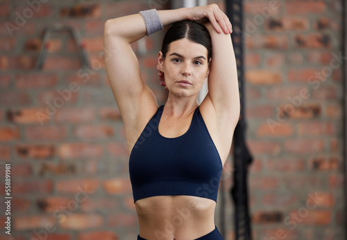 Fitness, portrait and woman stretching arms for gym exercise, workout or training in Australia. Female athlete with focus, warm up and body to start performance, wellness and energy for healthy goals
