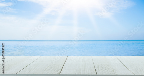 Beautiful wooden floor and blue background, sea water and sky.