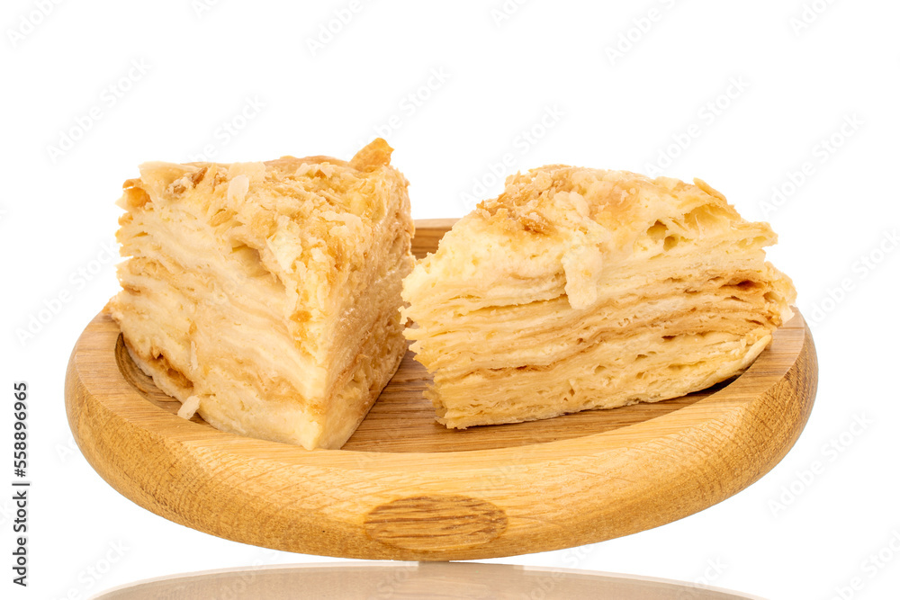 Two pieces of cream cake on a wooden tray, macro, isolated on white background. Two pieces of cream cake on a wooden tray, macro, isolated on white background.
