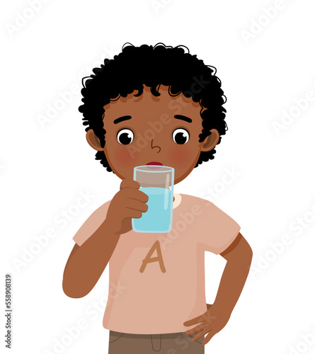 cute little African boy feeling thirsty drink a glass of water