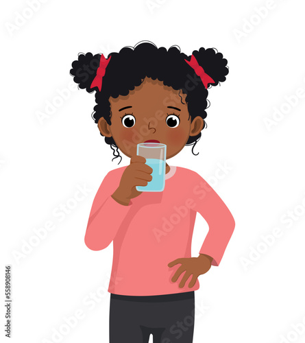 cute little African girl feeling thirsty drink a glass of water