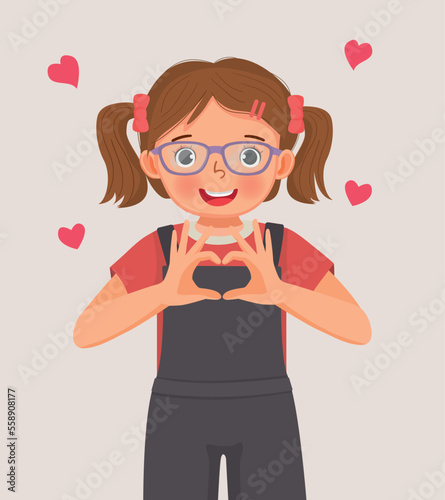 cute little girl showing heart shape sign with hands gesture symbol of love for valentine days celebrations