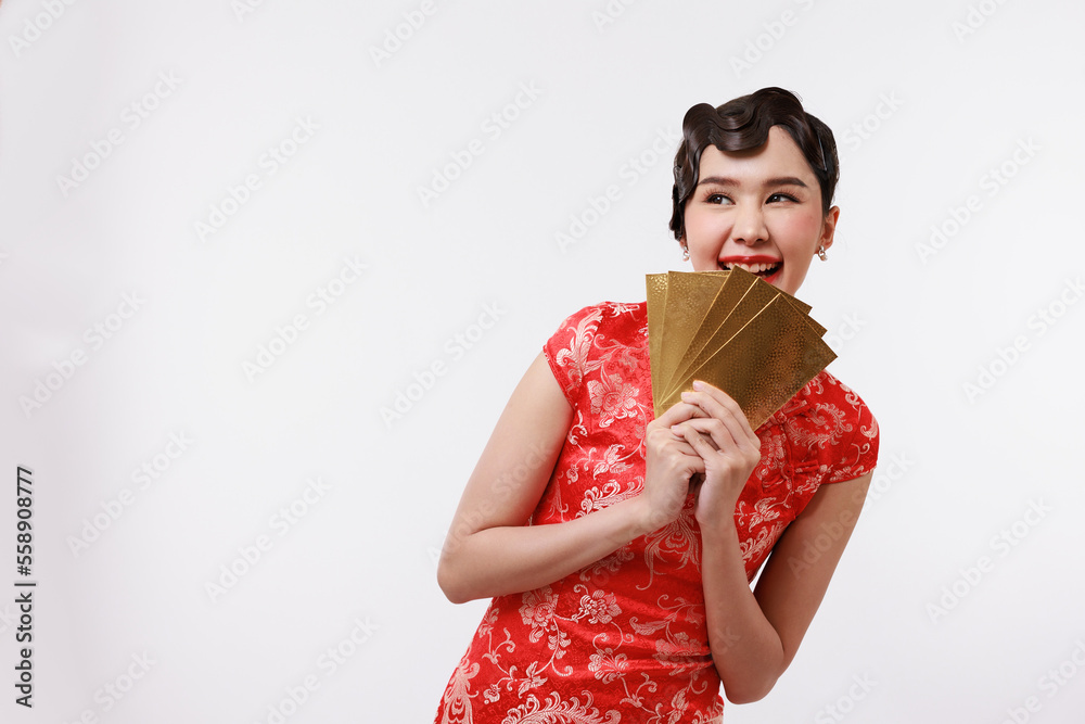 Smiling young beautiful asian woman in traditional chinese dress holding gold envelopes or Ang Pao on isolated white background. Smiling young beautiful asian woman in traditional chinese dress holding gold envelopes or Ang Pao on isolated white background.