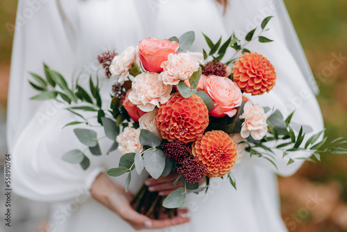 Wedding flowers. Bridal bouquet with exotic flowers. The bride is holding a bouquet. soft focus