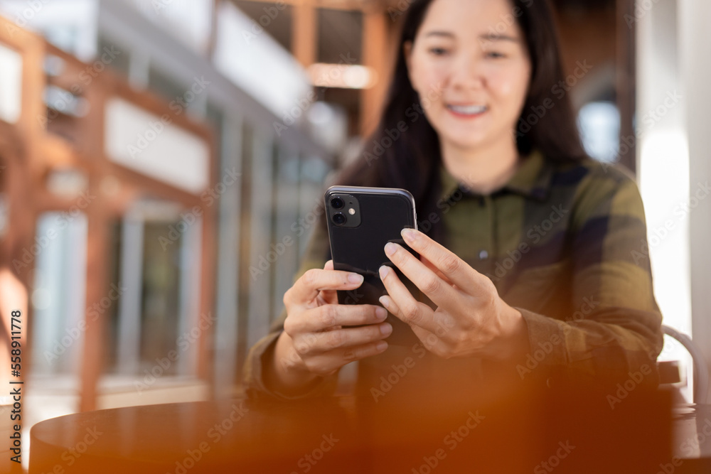 woman using cell phone hand holding mobile texting message contact us.chatting,search internet information in office.technology device communication connecting