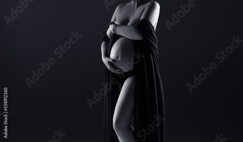 pregnant woman in black dress on a grey background