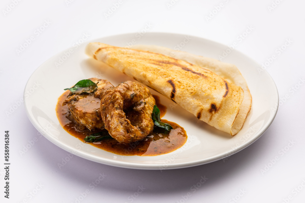 dosa with with fish curry from south Indian non vegetarian cuisine served in a plate dosa with with fish curry from south Indian non vegetarian cuisine served in a plate