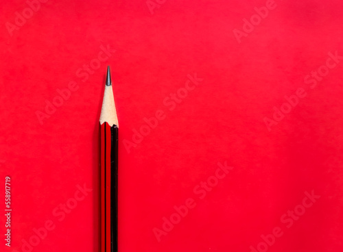 Red pencil on red background
