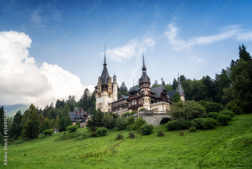 Amazing panoramic picture of the beautiful Peles Castle and its beautiful gardens near Sinaia, Romania.
