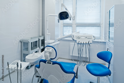 Fototapeta Naklejka Na Ścianę i Meble -  Modern dental office interior with equipment, patient chair and dentist's workplace in hospital