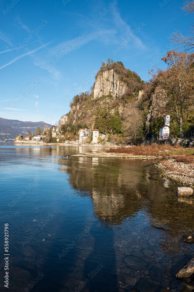 Old ruined furnaces with chimneys with red bricks reflecting on the water of Lake Maggiore in the Parco delle Fornaci in Caldè Old ruined furnaces with chimneys with red bricks reflecting on the water of Lake Maggiore in the Parco delle Fornaci in Caldè
