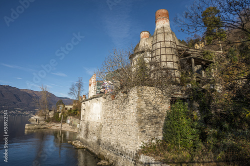 Red brick chimneys and abandoned furnaces with vegetation covering them in Caldè on Lake Maggiore photo