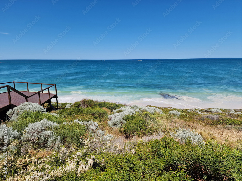 Beach with wooden platform on a beach in West Australia with a view over the Indian Ocean.