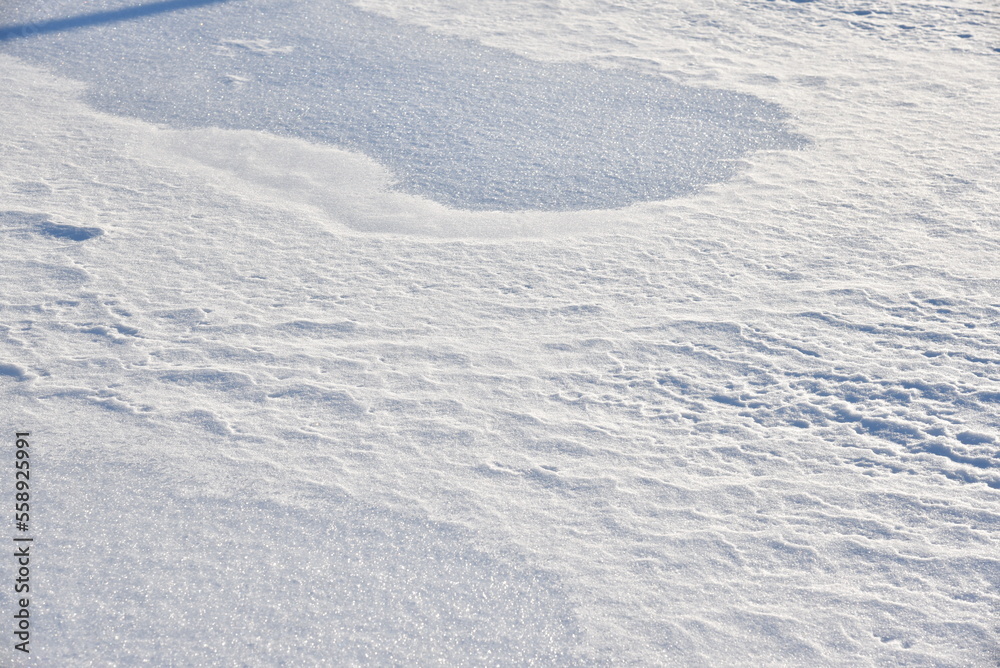 Snowy surface. White snow and snowdrifts in winter.