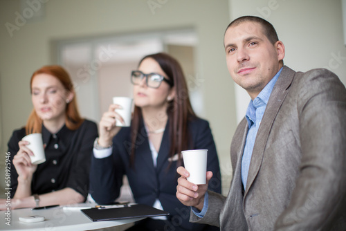 Business people talking and drinking coffee during a break during a meeting