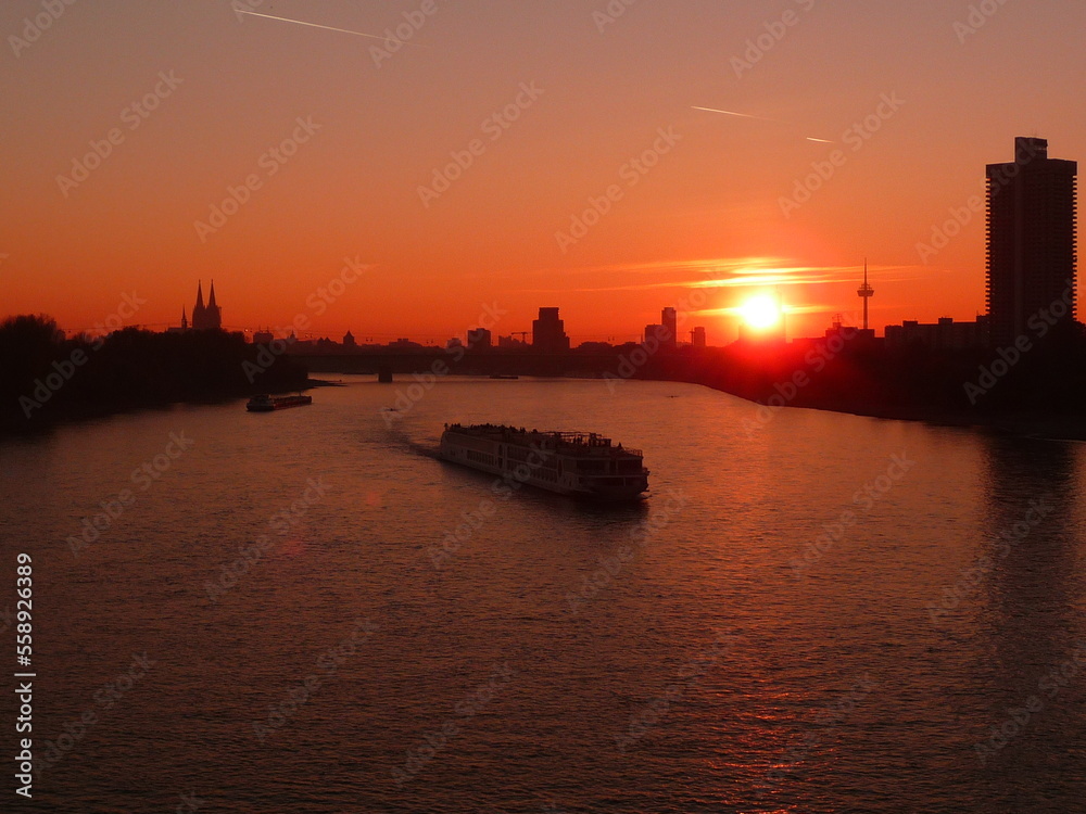 Sunset from the Mülheimer Brigde in Cologne with a Ship on the Rhine Germany