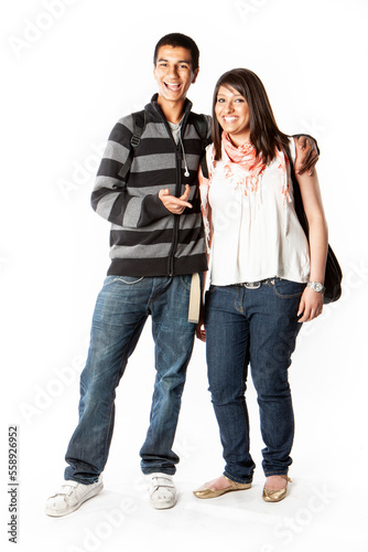 Teenage Students: Good Friends. Happy smiles from a pair of late teenage Indian school friends isolated on white. From a series of related images.