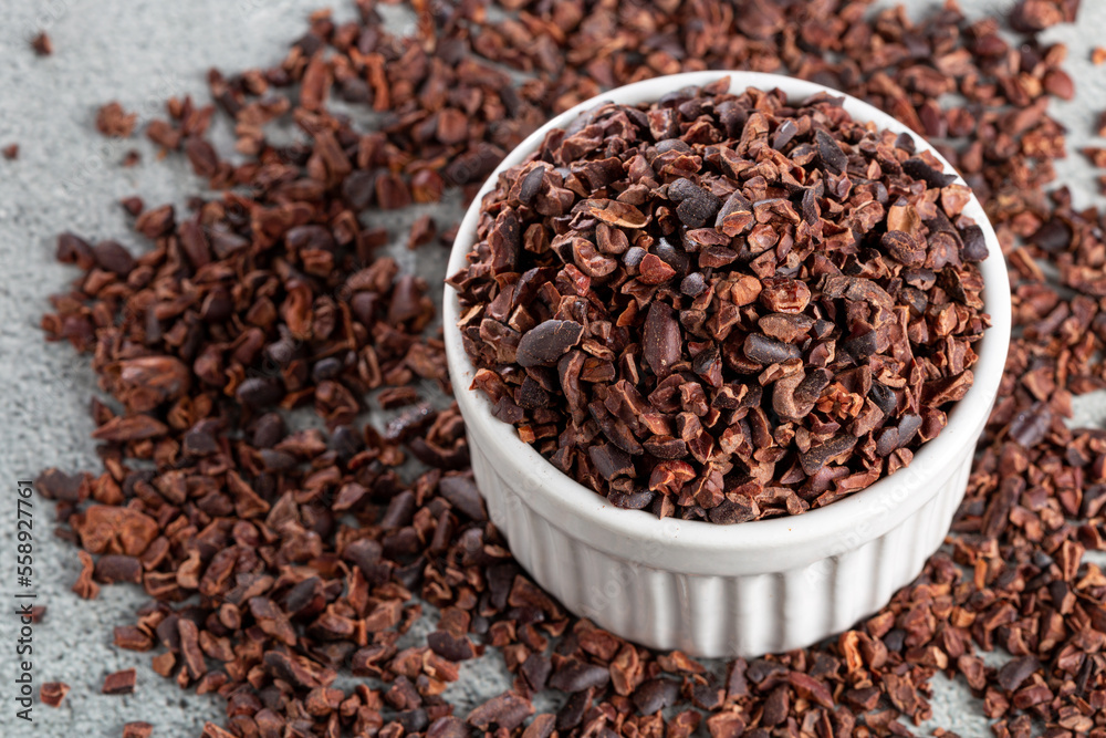 Bowl with cocoa nibs on the table.