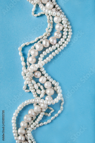 Pearl necklace on blue