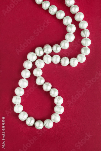 Pearl necklace on red